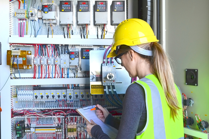 Female Inspector checking electric panels